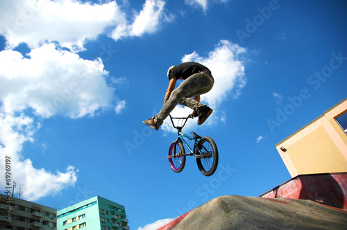 Teenage boy doing tricks on his BMX bike