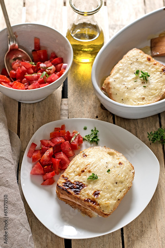 French sandwiches Croque-Monsieur with bechamel sauce and tomato