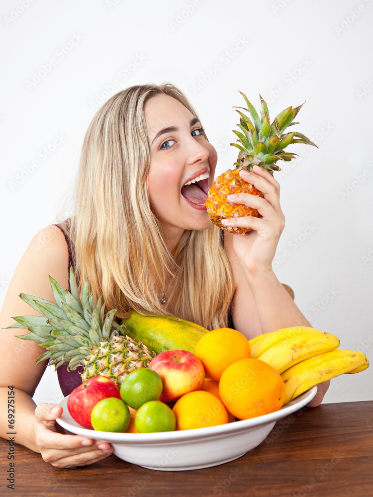 Young healthy beautiful woman with a bowl of fresh exotic fruit Young healthy beautiful woman with a bowl of fresh exotic fruit