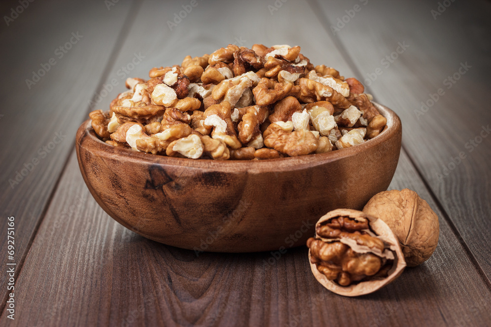 walnuts in the brown wooden bowl walnuts in the brown wooden bowl