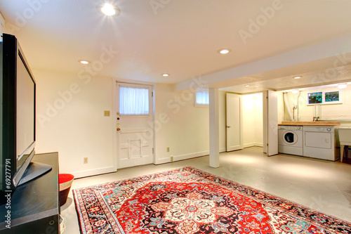 House interior. Basement room with TV and laudry area photo