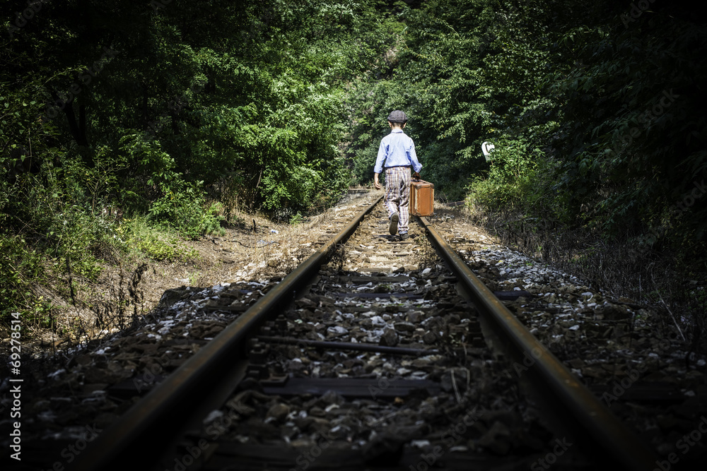 Fototapeta premium Child walking on railway