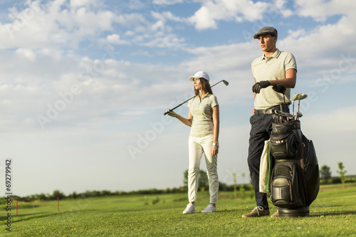 Young couple at golf cart