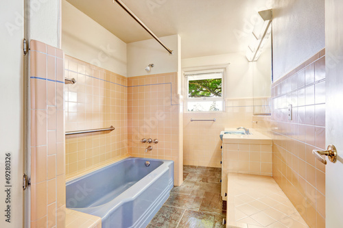 Ivory bathroom with blue bath tub