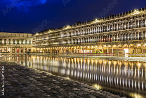 San Marco square with reflection on water at night, Venice.