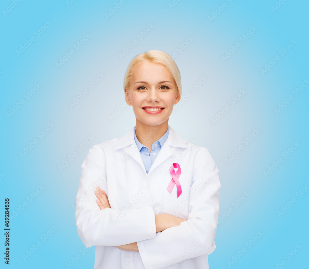 smiling female doctor with cancer awareness ribbon smiling female doctor with cancer awareness ribbon