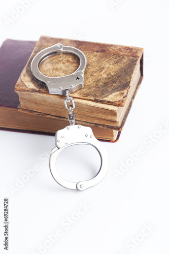 handcuffs and book of law 