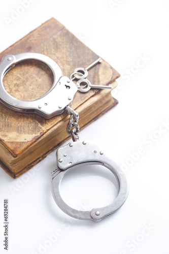 handcuffs and book of law 