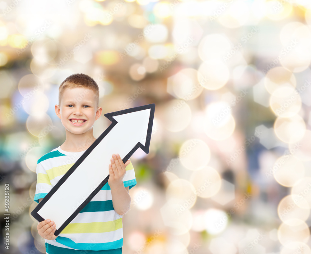 smiling little boy with blank arrow pointing right smiling little boy with blank arrow pointing right