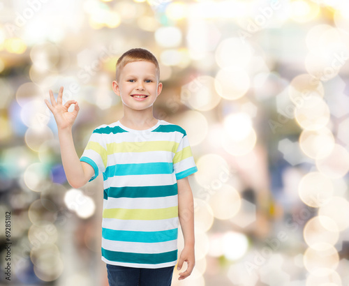 little boy in casual clothes making OK gesture