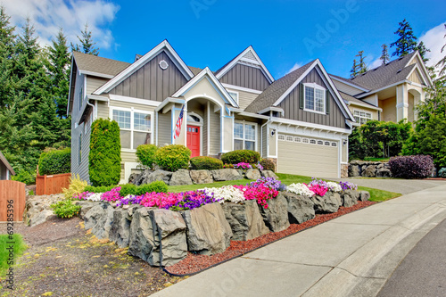 American house with beautiful landscape and vivid flowers