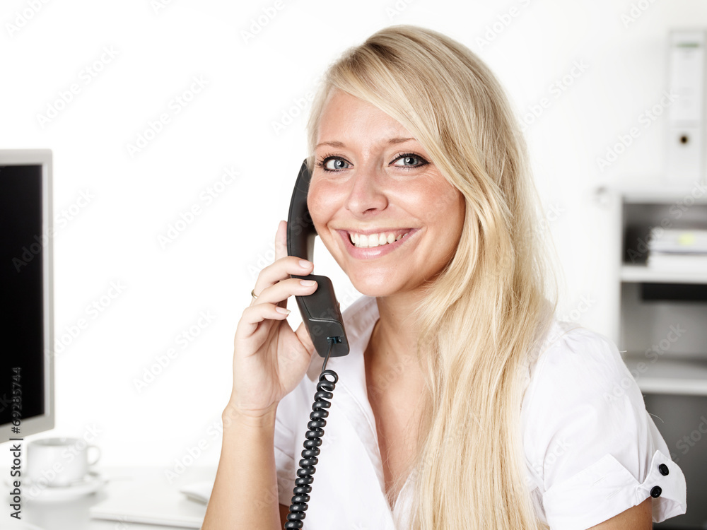 Female office assistant has a call at the office Female office assistant has a call at the office