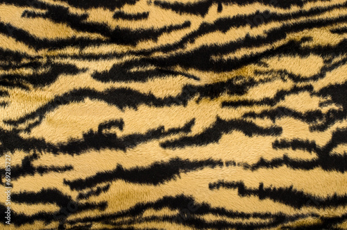 Brown and black tiger pattern. Fur animal print as background.