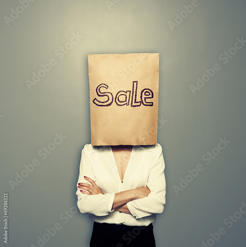 woman with paper bag over grey