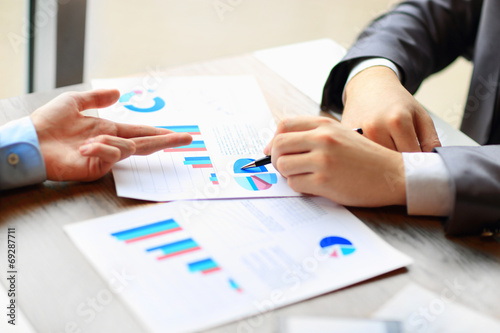 Image of human hands with pens pointing