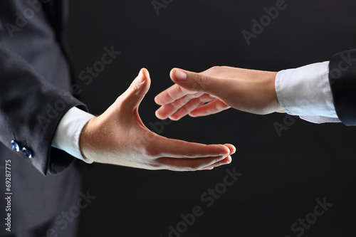 hands of business partners before handshake © yurolaitsalbert