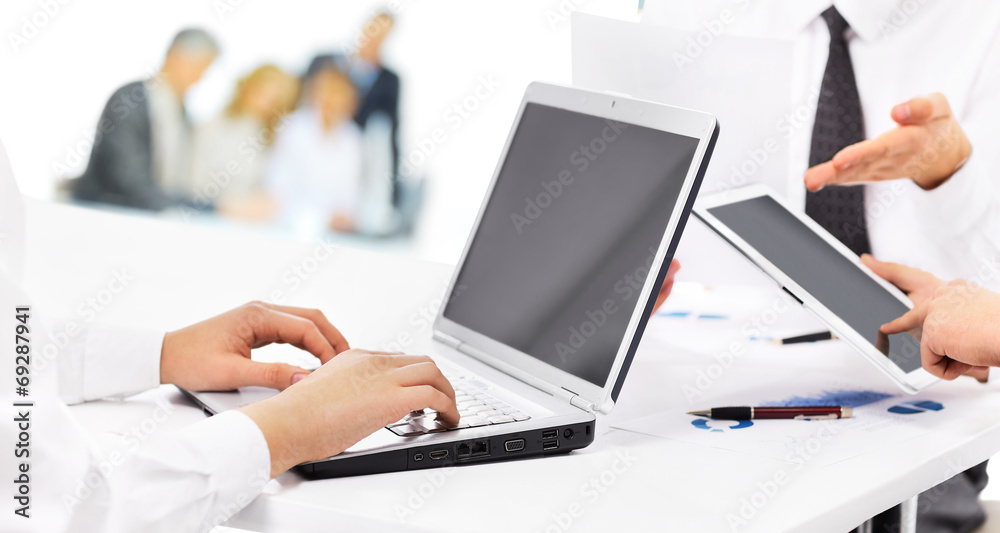 business partners using laptop at meeting business partners using laptop at meeting