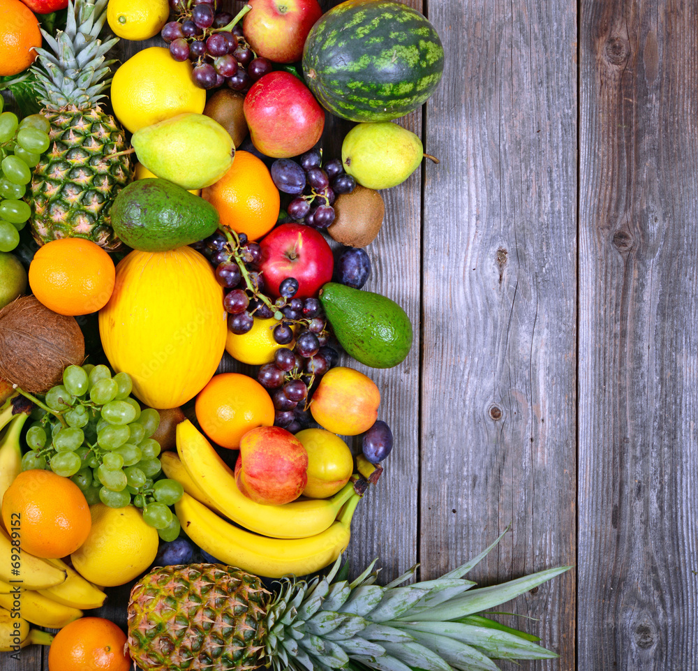 Huge group of fresh colorful fruit on wooden background - Health Huge group of fresh colorful fruit on wooden background - Health