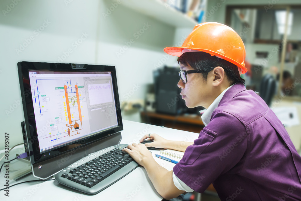 Engineer student looking simulated oil distillation in computer Engineer student looking simulated oil distillation in computer