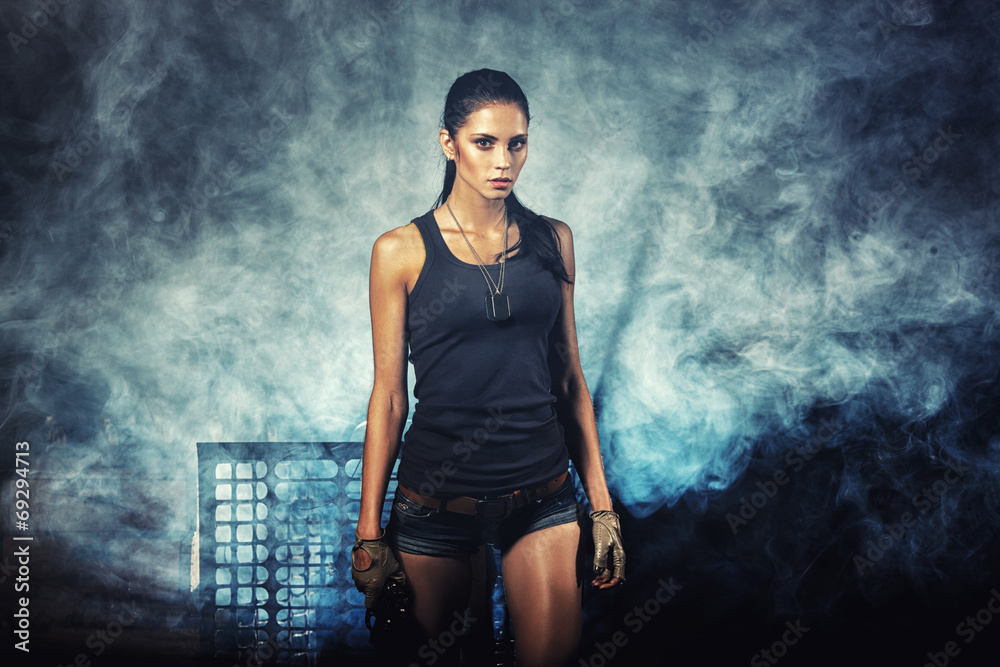 sexy woman standing on ruins and holding handgun sexy woman standing on ruins and holding handgun