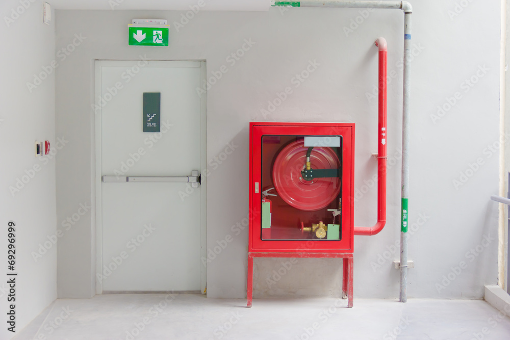 Fototapeta premium Fire exit door and fire extinguish equipment