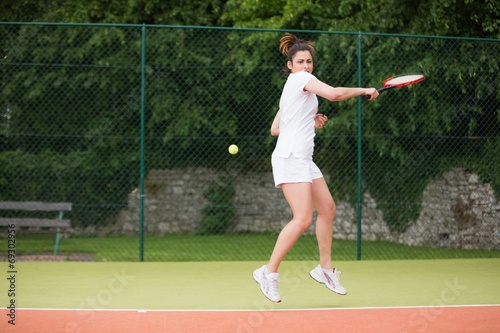 Pretty tennis player playing on court © WavebreakmediaMicro
