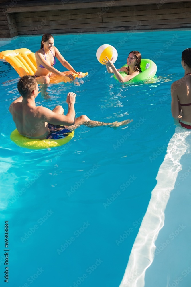 People playing with ball in swimming pool