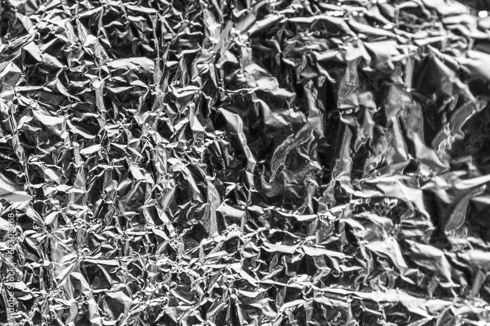 Foil with reflection of light. Focus on left side. Foil with reflection of light. Focus on left side.