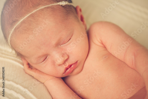 Close portrait of Newborn Baby Sleeping with Band