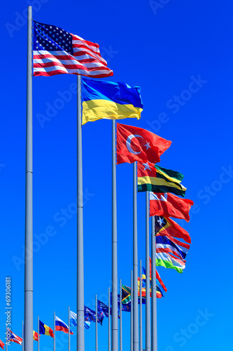 Foto Flags against blue sky, copyspace