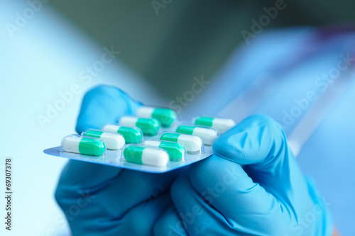 female doctor holding medicine capsules