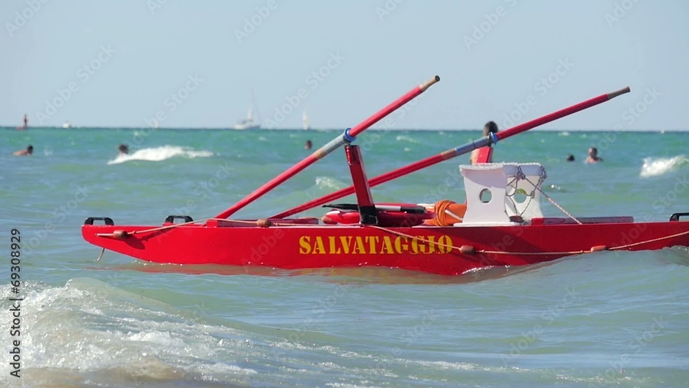 typical red rescue boat and swimmers, Rimini, Italy