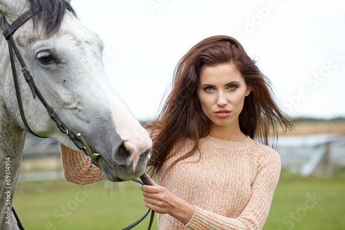 woman long hair kissing beautiful horse
