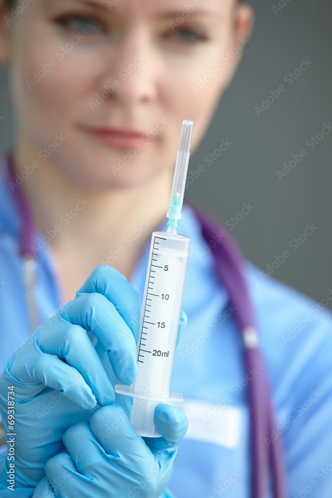 female doctor holding a syringe female doctor holding a syringe
