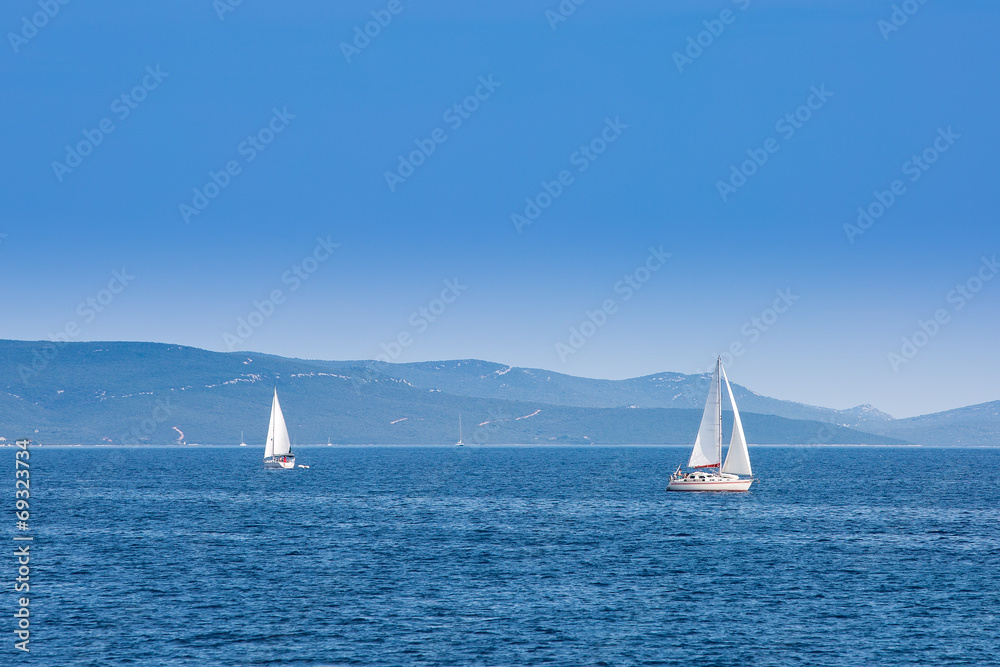 Fototapeta premium Two sailboats sailing on the Adriatic Sea in Croatia