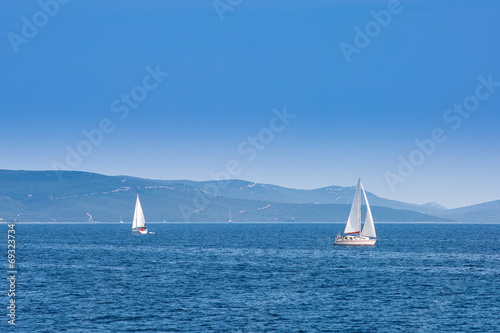 Two sailboats sailing on the Adriatic Sea in Croatia