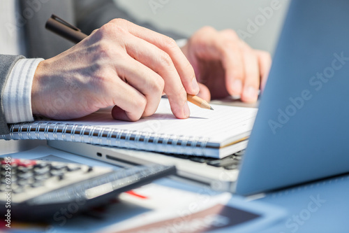 Businessman analyzing investment charts with laptop. Accounting