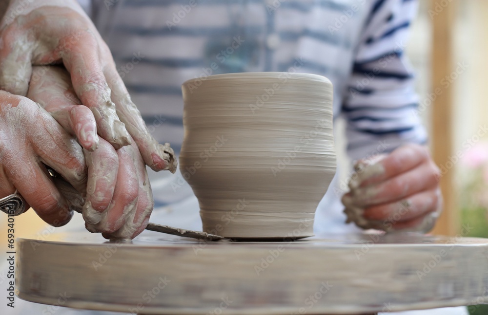 Children's hands creating new vase Children's hands creating new vase