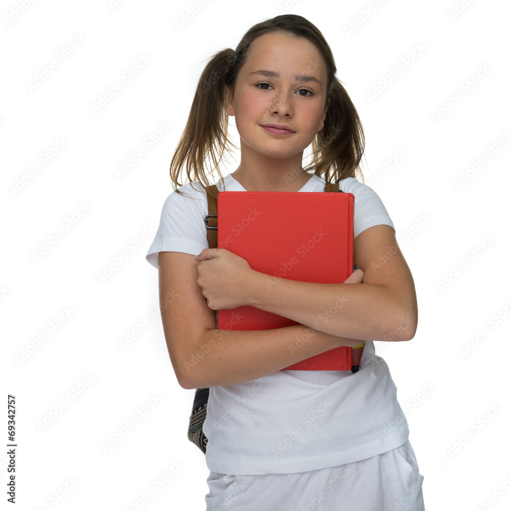 Young schoolgirl clutching a text book Young schoolgirl clutching a text book