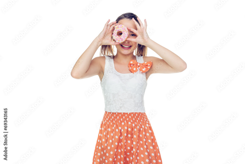 Laughing young girl holding a donut to her eye Laughing young girl holding a donut to her eye