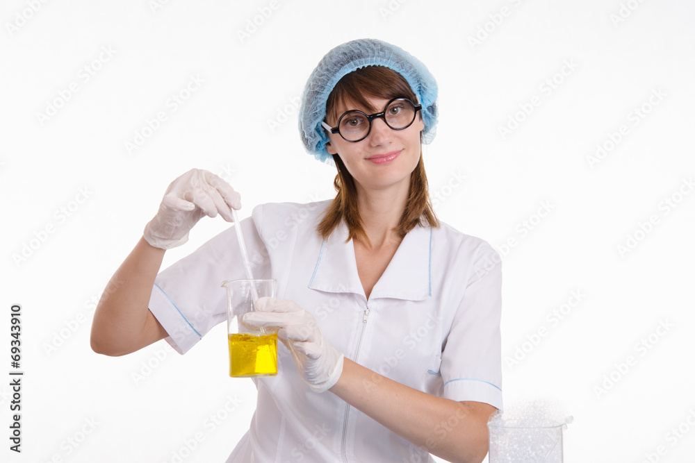 Chemist mixes the contents of flask Chemist mixes the contents of flask