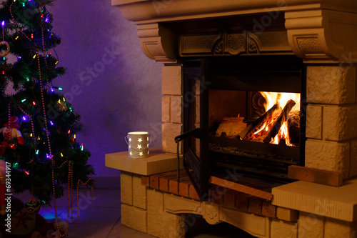 Chimney with fire and decorated Christmas tree