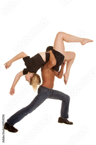 a man lunging holding up a woman on her shoulder