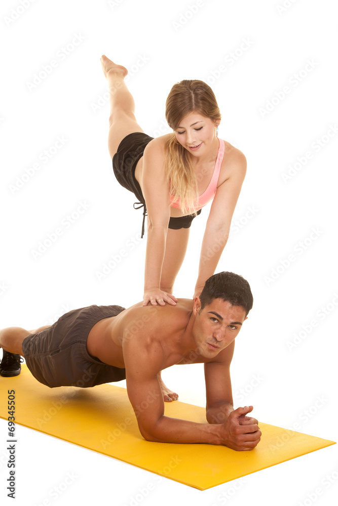 fitness woman kick up leg by man in plank look down fitness woman kick up leg by man in plank look down