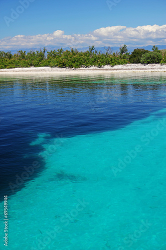 Coast in smooth water. Azure clean water