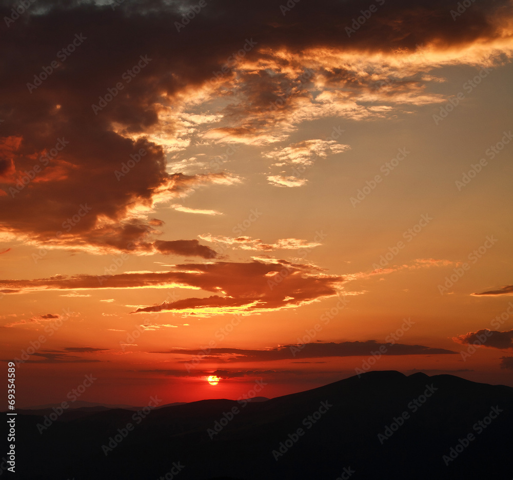 Dramatic sunset with clouds, in mountains, nature background