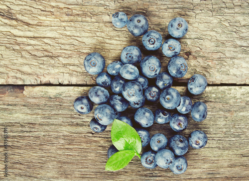 fresh blueberries on wooden surface
