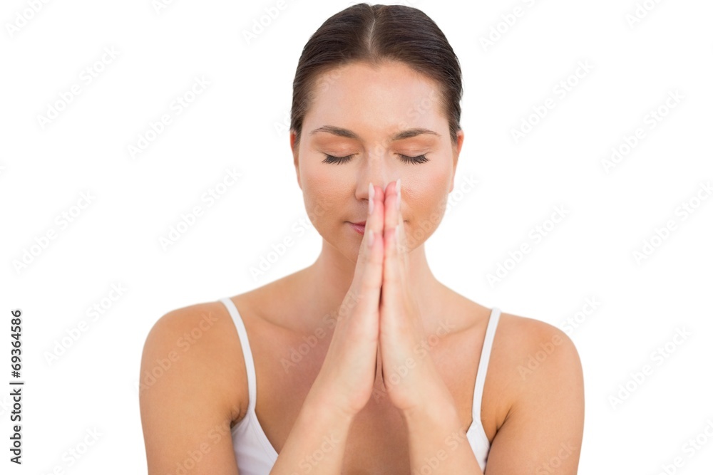 Peaceful brunette meditating with hands together Peaceful brunette meditating with hands together