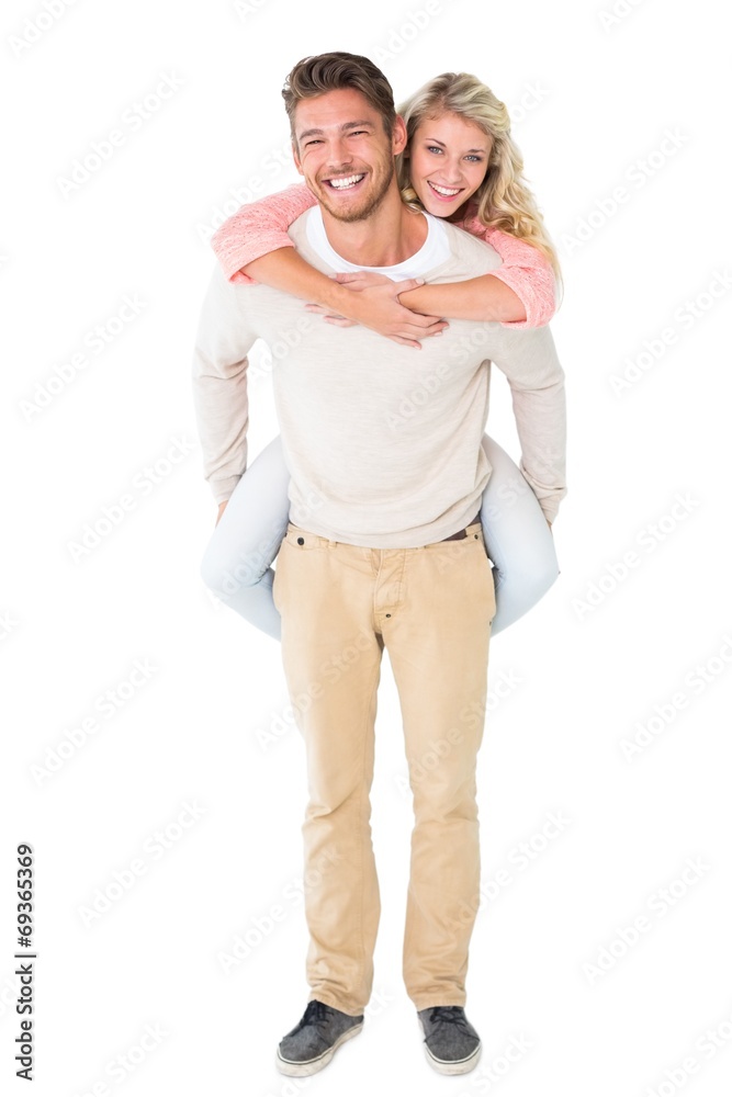Handsome man giving piggy back to his girlfriend Handsome man giving piggy back to his girlfriend