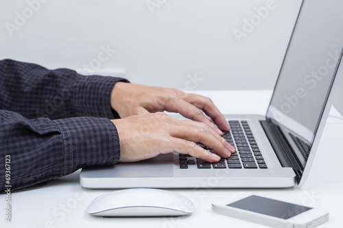 Man hands typing on laptop computer